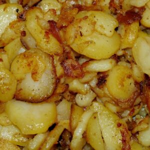 Close-up of German fried potatoes with crispy edges.