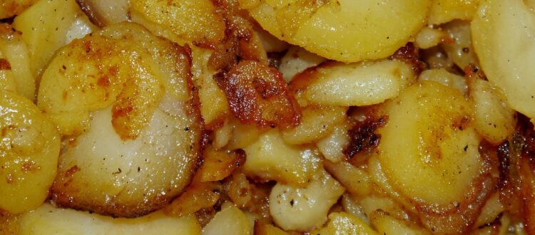 Close-up of German fried potatoes with crispy edges.