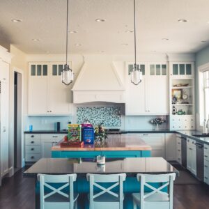 Traditional German kitchen with wooden cabinets, tiled backsplash, and various kitchen utensils.