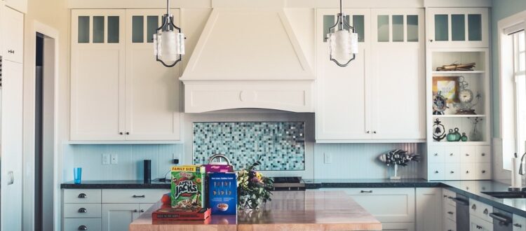 Traditional German kitchen with wooden cabinets, tiled backsplash, and various kitchen utensils.