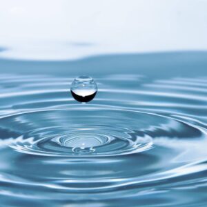 Various types of water in Germany, including mineral water bottles and a glass of refreshing tap water.